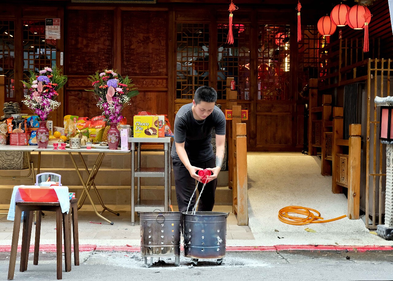A libation ceremony: Toasting the departed with rice wine
